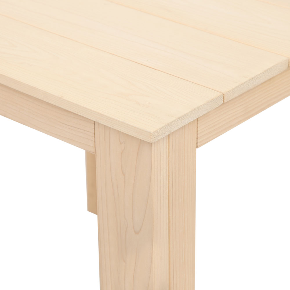 Close-up of the timber side table's tabletop corner and leg.