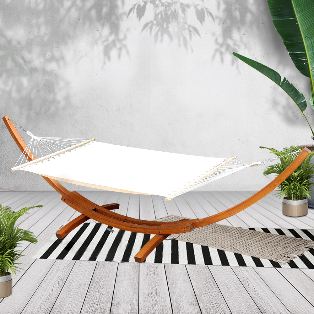 Front angled view of the cream hammock and timber stand on a deck; styling accessories not included.