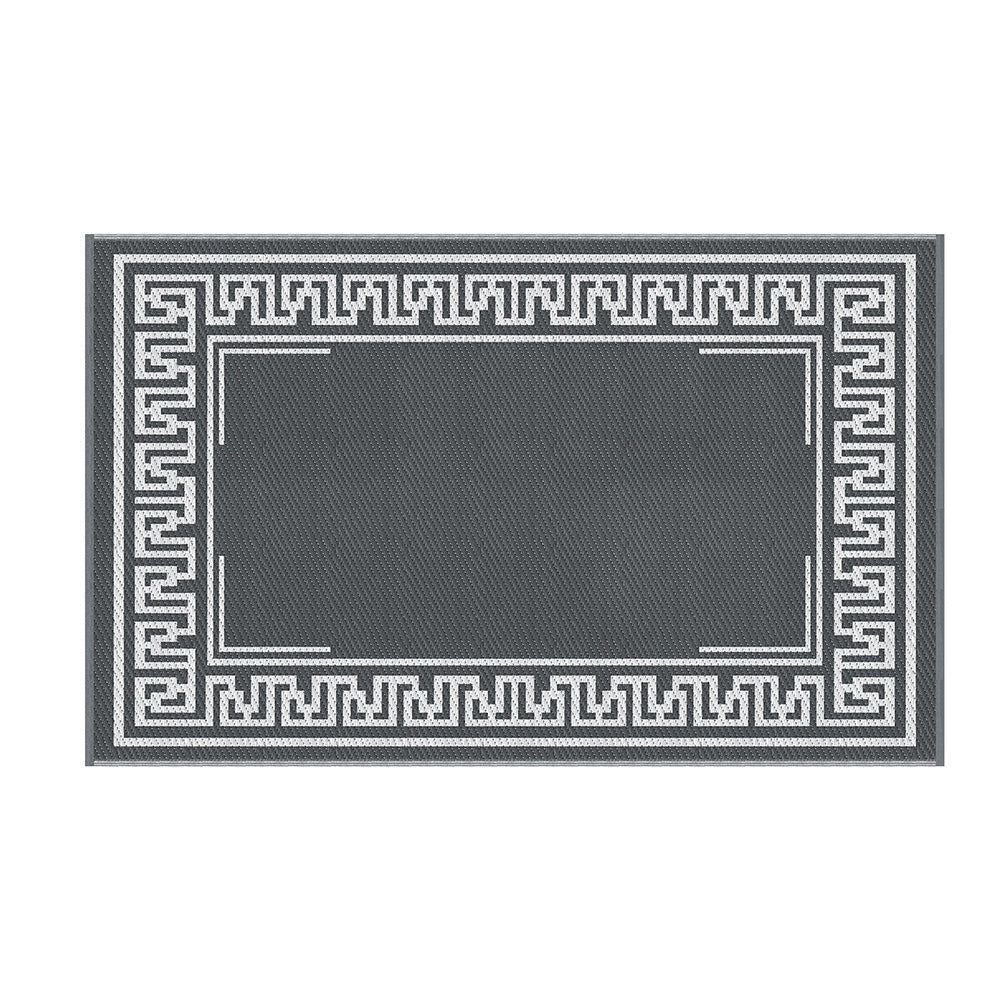 Overhead view of the grey outdoor rug and its white Greek key border.
