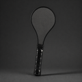 Black carbon fibre sweet-spot training paddle on a charcoal studio background